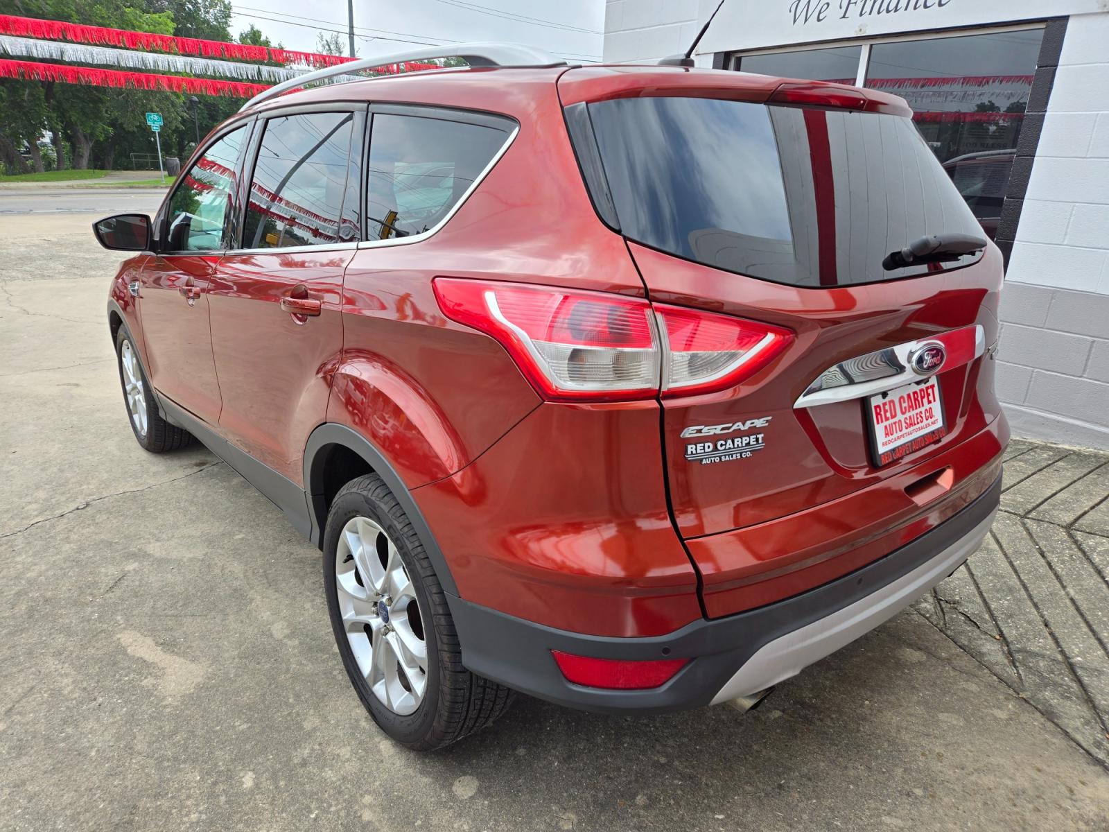 2014 Orange Ford Escape Titanium 4WD (1FMCU9JX7EU) with an 1.6L L4 DOHC 16V engine, 6-Speed Automatic transmission, located at 503 West Court, Seguin, TX, 78155, (830) 379-3373, 29.568621, -97.969803 - Photo #3